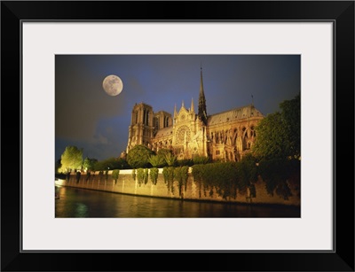 Notre Dame Cathedral at night, with moon rising above, Paris, France, Europe