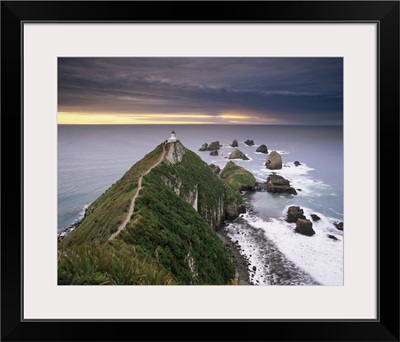 Nugget Point lighthouse on the coast and overcast sky, the Catlins, New Zealand