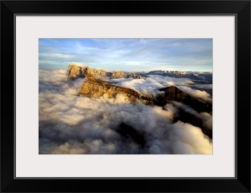 Aerial shot from Seceda of Odle surrounded by clouds at sunset in the Dolomites, Val Funes, Trentino-Alto Adige South Tyro...