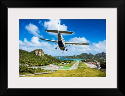 Small airplane landing at the airport of St. Barth, Lesser Antilles