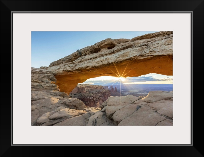 The sun is rising under Mesa Arch, Canyonlands National Park, Moab, Utah, United States of America, North America