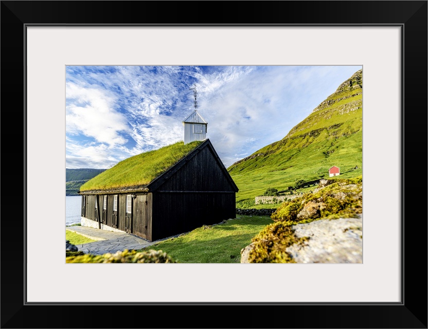 Traditional church with grass roof overlooking the fjord, Funningur, Eysturoy Island, Faroe Islands, Denmark, Europe