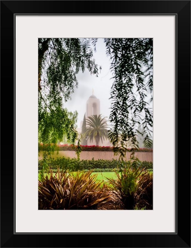 The Newport Beach California Temple is surrounded by lush green grass, shrubs, and trees. It was dedicated in 2003 by Duan...