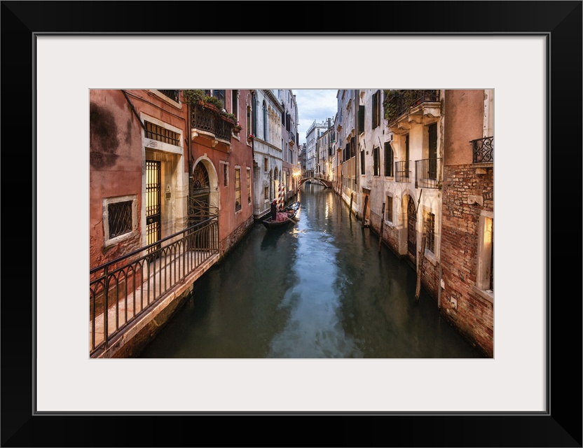 Gondola rowing in the canals of venice