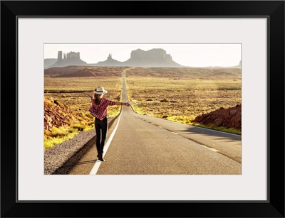 Hitchhiker on Forrest Gump highway by Monument Valley, Arizona