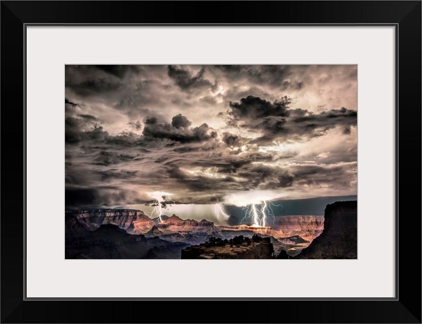 Photograph of lightning bolts striking gorge after sunset during a thunderstorm.