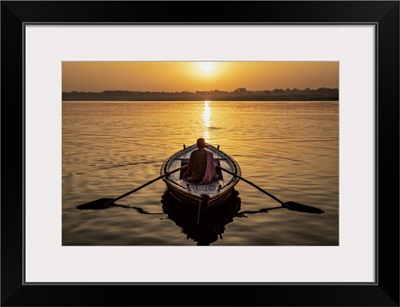 Man Rowing A Longtail Boat On The Ganges River, Varinasi, India