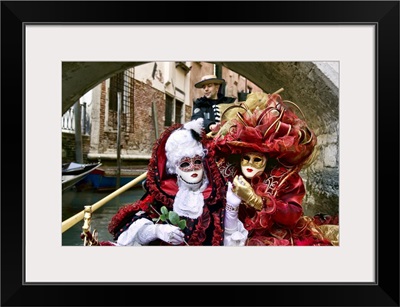 Masquerade time on gondola during Carnival, Venice, Italy