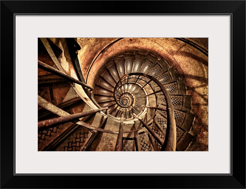 Photograph of a vintage flight of steps made of metal enclosed by brick that circles to the top of a brick column.