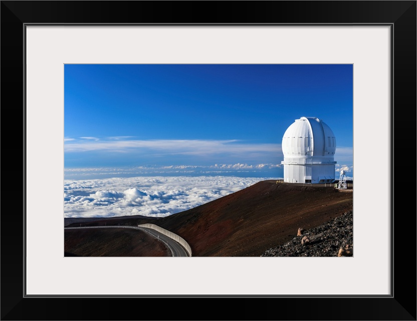 Big Island Hawaii. The late afternoon sun illuminates an observatory atop Hawaii's Mauna Kea at sunset.