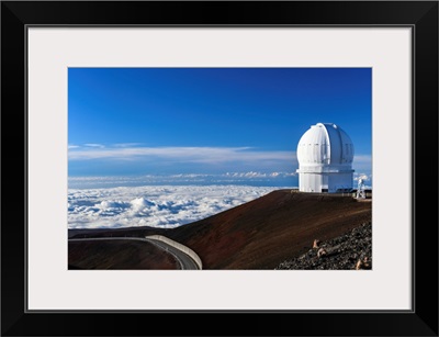 The Late Afternoon Sun Illuminates An Observatory Atop Hawaii's Mauna Kea At Sunset