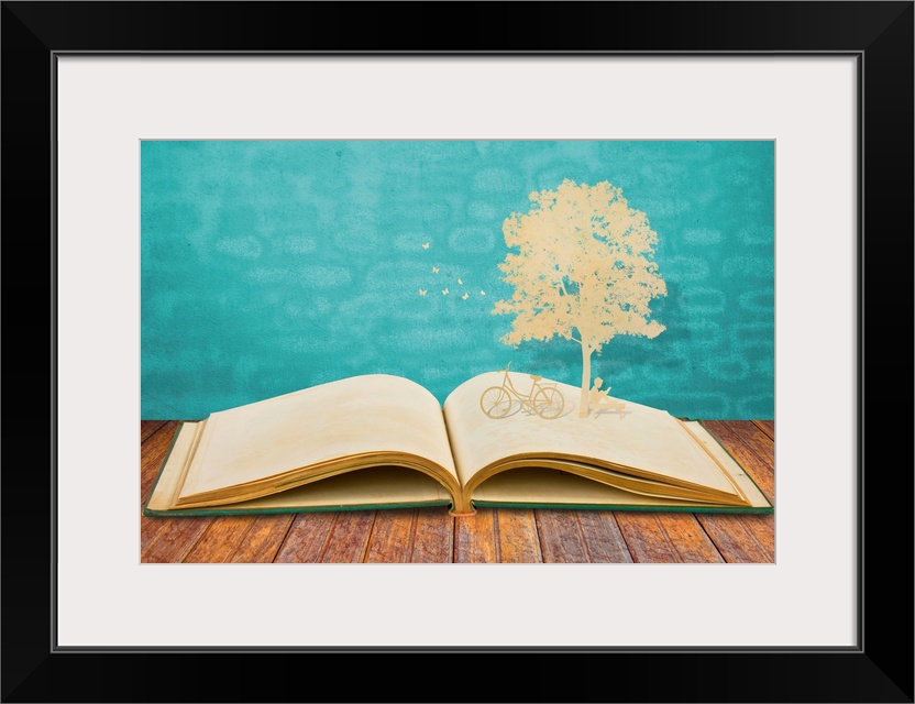 Paper cut of children read a book under tree on old book