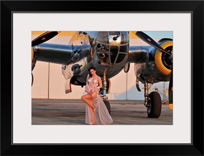 1940's pin-up girl in lingerie posing with a B-25 bomber