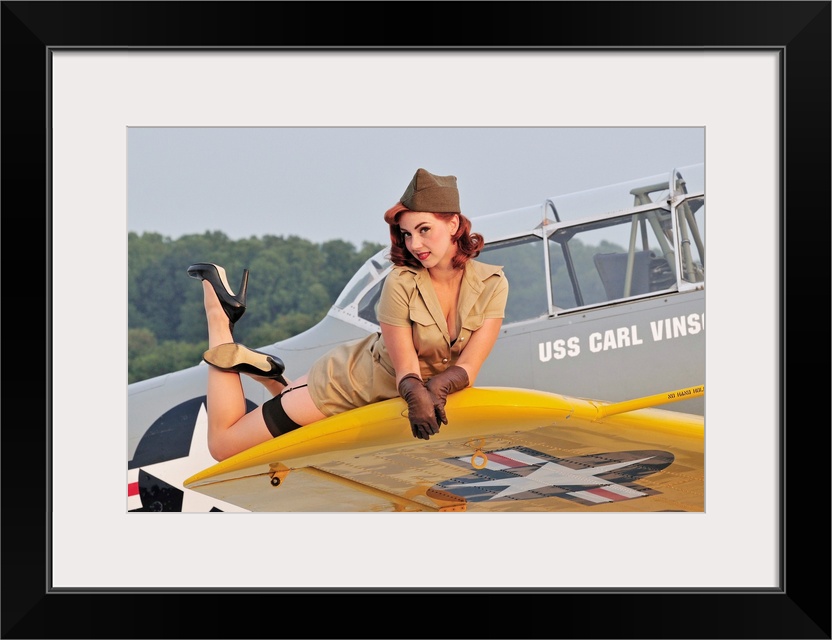 1940's style pin-up girl lying on a T-6 Texan training aircraft.