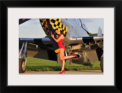 1940's style pin-up girl posing with a P-51 Mustang
