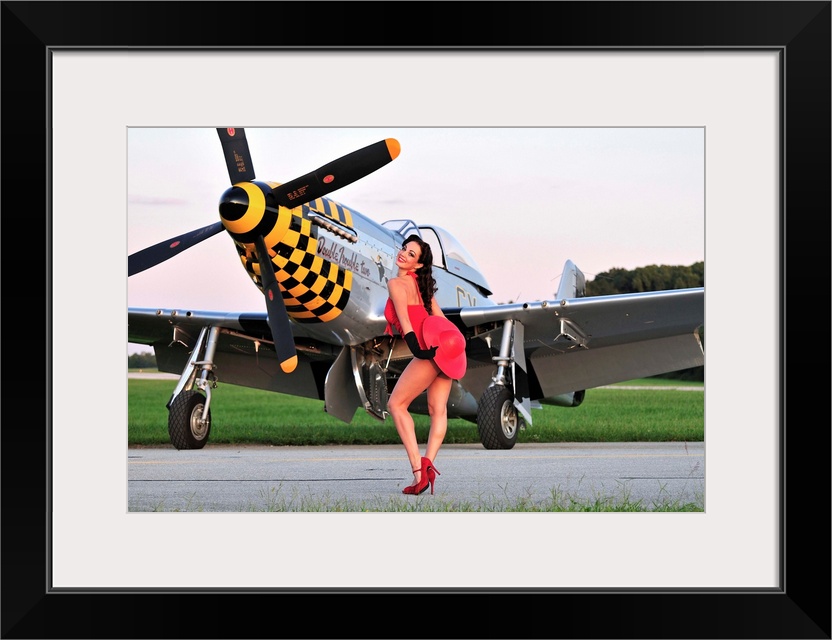 Sexy 1940's style pin-up girl posing with a P-51 Mustang fighter plane.