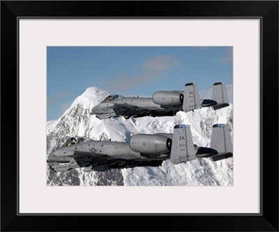A-10 Thunderbolt II's Fly Over Mountainous Landscape