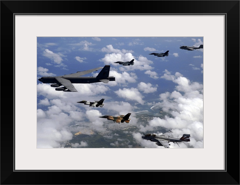 Military aircrafts are photographed flying high and in formation over Guam.