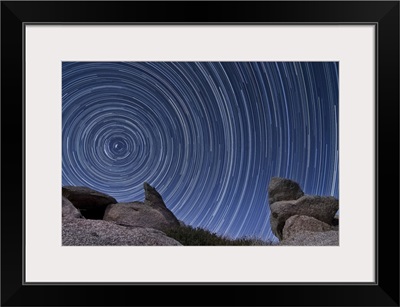 A boulder outcropping and star trails in Anza Borrego Desert State Park, California