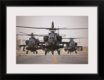 A group of AH-64D Apache helicopters on the runway at COB Speicher