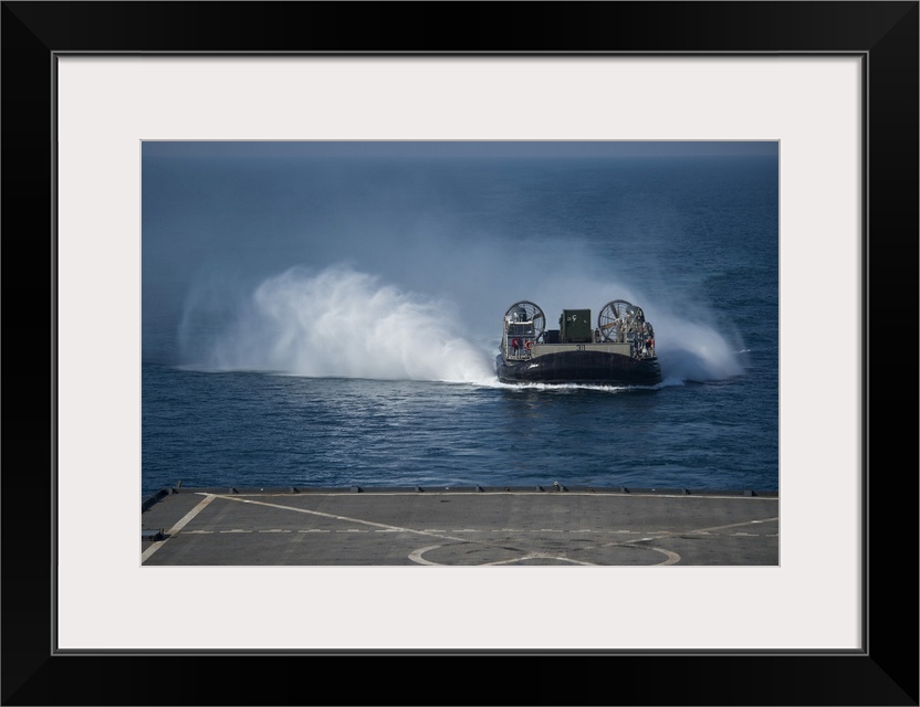 Arabian Gulf, December 10, 2014 - A Landing Craft Air Cushion makes its approach to the well deck of the amphibious dock l...