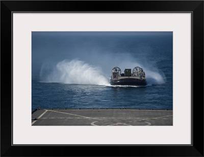 A Landing Craft Air Cushion Makes Its Approach To The Well Deck Of USS Comstock