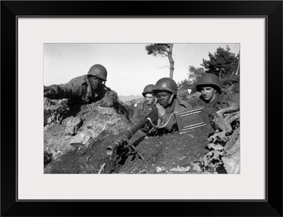 A machine gun crew in firing position during the Korean War