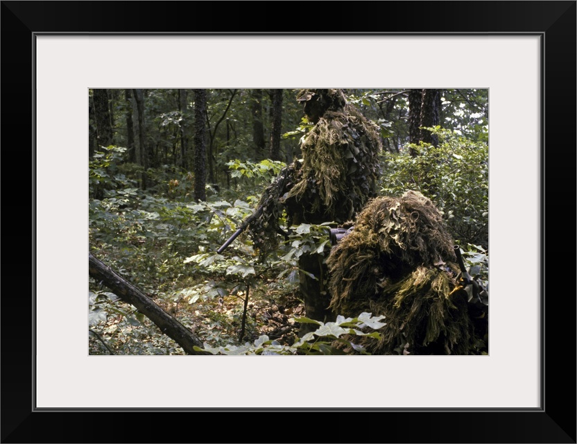 A Marine sniper team wearing camouflage ghillie suits on a training patrol at the Marine Corps Development and Education C...