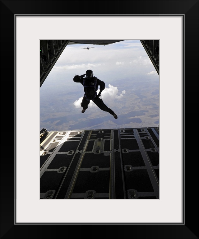 March 18, 2011 - A paratrooper salutes as he exits a C-130J Super Hercules during a combined high-altitude, low-open jump,...