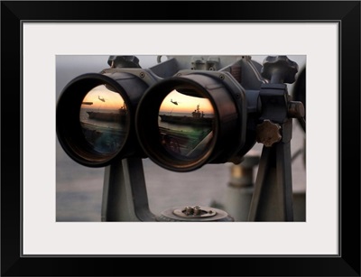Aircraft carrier USS Dwight D Eisenhower is reflected in a set of Big Eyes binoculars