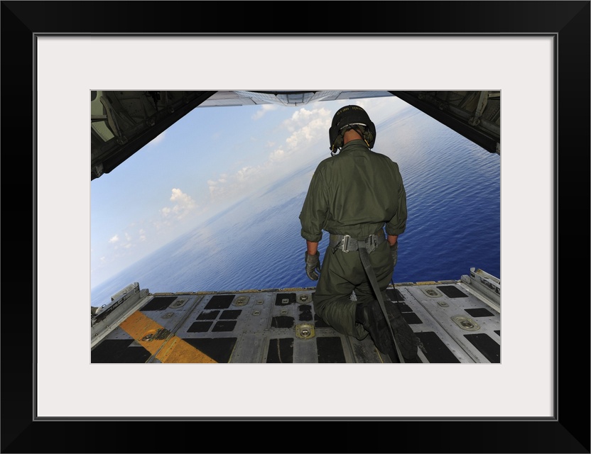 St. Petersburg, Florida, May 29, 2010 - Airman observes the waters of the Gulf of Mexico from a C-130 Hercules. The C-130 ...