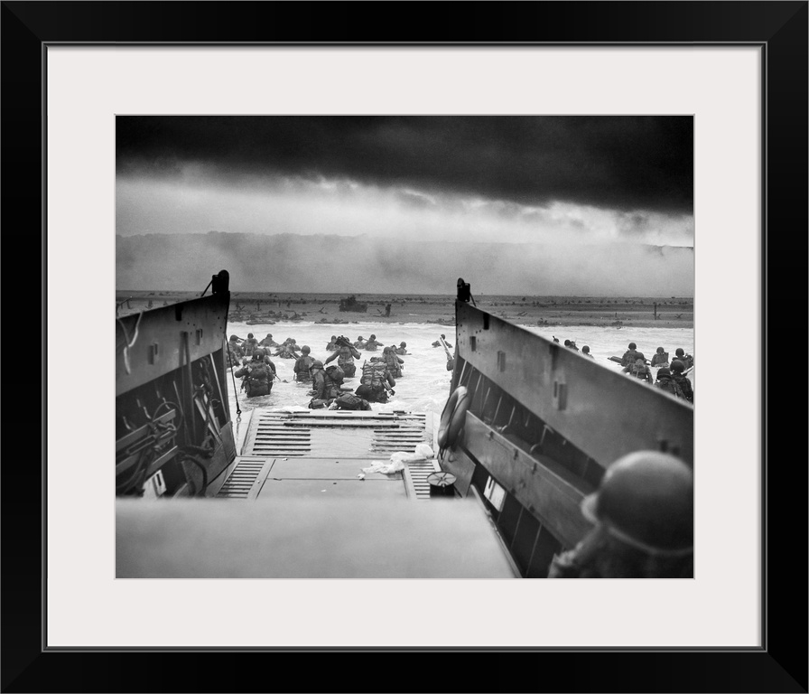 Digitally restored vintage World War II photo of American troops wading ashore on Omaha Beach during the D-Day invasion on...