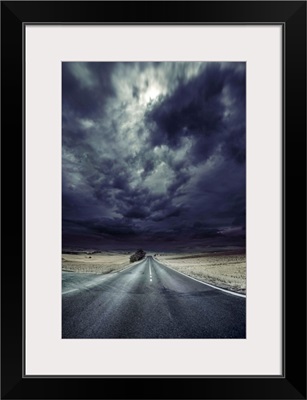 An asphalt road with stormy sky above, Tuscany, Italy