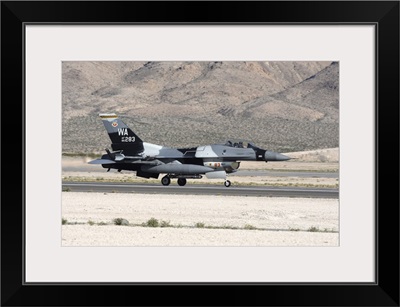 An F-16C Aggressor jet landing on runway in Nevada