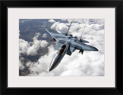 An F15C Aggressor flies over a mountain range