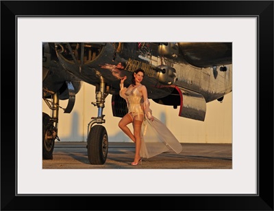 Beautiful 1940's pin-up girl standing with a B-25 bomber