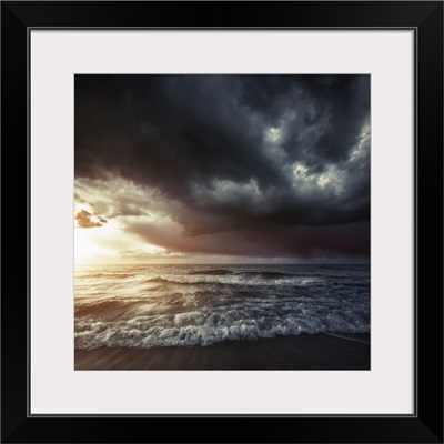 Bright sunset against a wavy sea with stormy clouds, Hersonissos, Crete