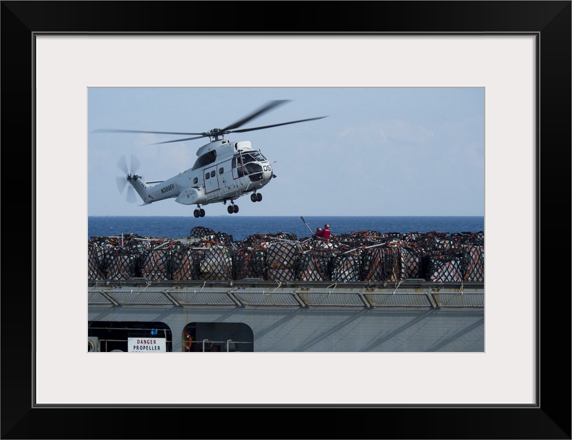 Andaman Sea, January 14, 2015 - An AS-332 Super Puma helicopter attached to dry cargo and ammunition ship USNS Carl Brashe...