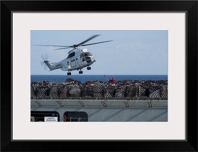 Cargo Is Being Attached To An AS-332 Super Puma Helicopter