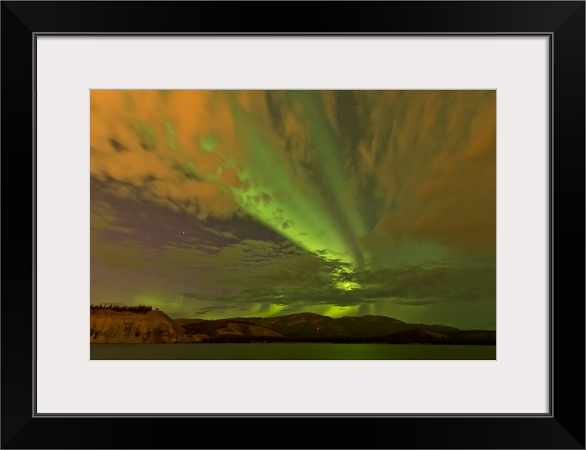 Colorful aurora borealis over lake, Yukon, Canada.