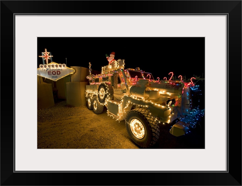 Cougar MRAP is adorned in holiday lights parked in front of EOD Iraq