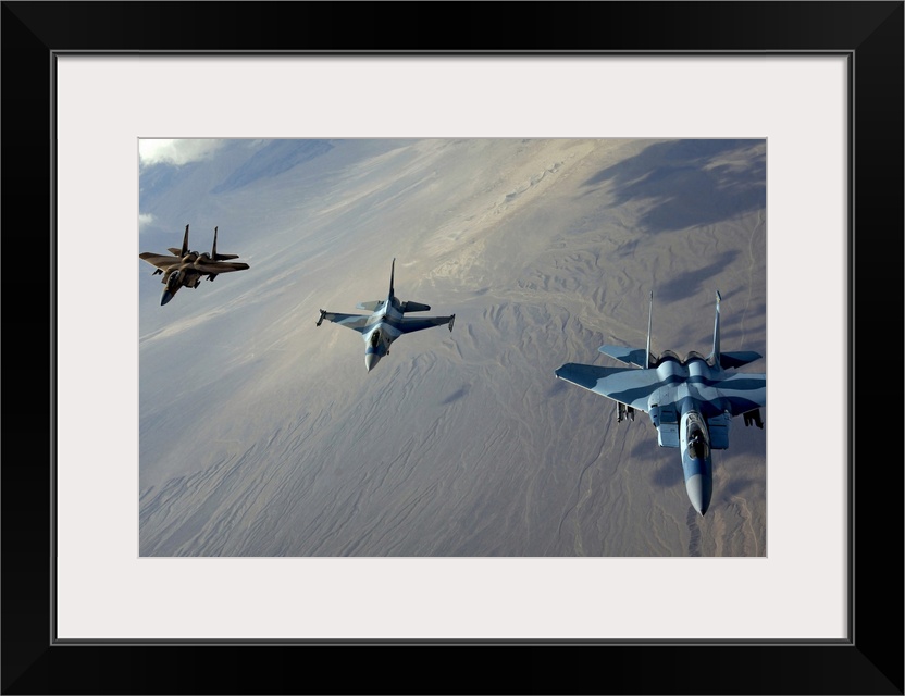 Big photo on canvas of three fighter jets flying in a diagonal line formation above a desert.