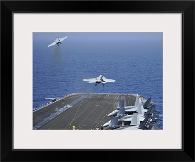 F/A-18F Super Hornets launch from the aircraft carrier USS Enterprise