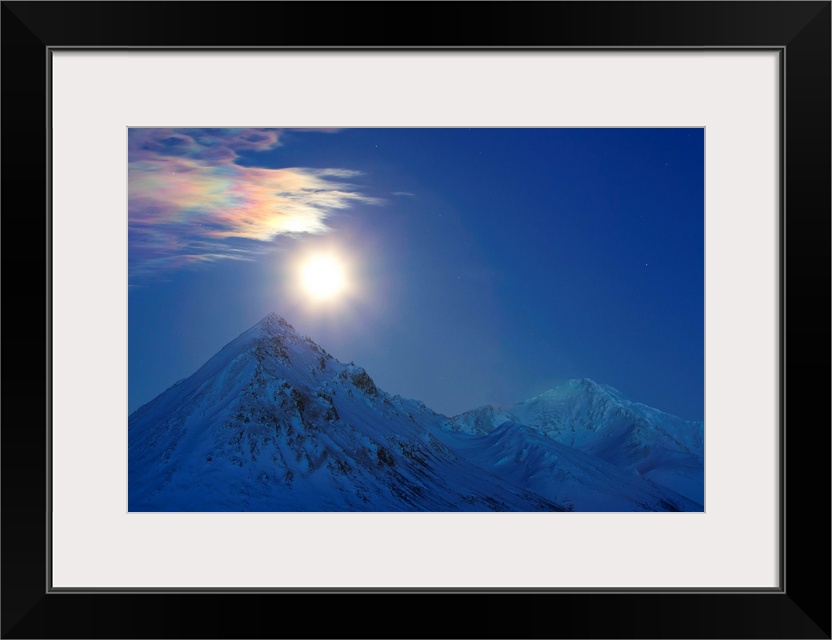 Full moon with rainbow clouds over Ogilvie Mountains, Tombstone Park, Dempster Highway, Canada.