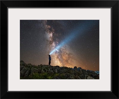 Man shining a flashlight on the Milky Way from Lago-Naki plateau in Russia