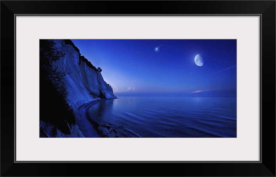 Moon rising over tranquil sea and Mons Klint cliffs against starry sky with falling meteorite, Denmark.