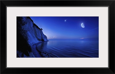 Moon rising over tranquil sea and Mons Klint cliffs, Denmark