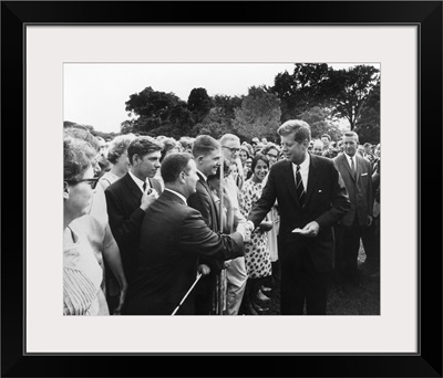 President Kennedy greets Peace Corps Volunteers on the White House South Lawn