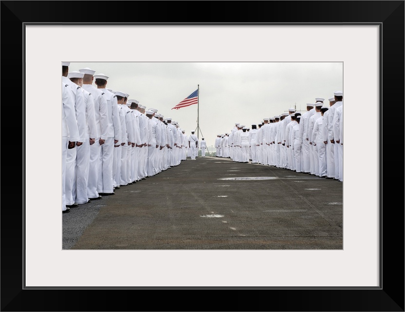 Atlantic Ocean, July 22, 2013 - Sailors prepare to man the rails on the flight deck of the aircraft carrier USS Harry S. T...