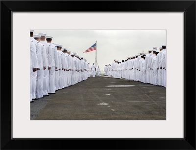 Sailors prepare to man the rails on the flight deck of USS Harry S. Truman